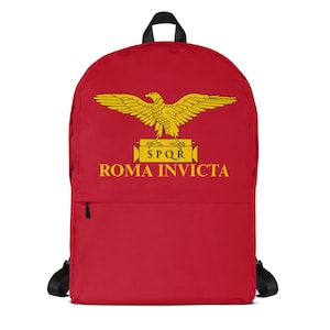May include: Red backpack featuring a yellow eagle emblem with the text "SPQR ROMA INVICTA." The backpack has black straps, a top handle, and a front pocket with a black zipper. The design is centered on the front of the bag.