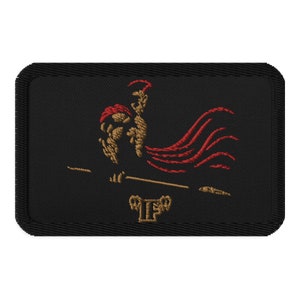 May include: A black embroidered patch featuring a gold and red image of a rooster standing on a skateboard. The rooster is wearing a red helmet and has a red cape.