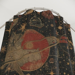 May include: A dark shower curtain with a celestial design. The curtain features a large red planet with a ring, surrounded by stars, constellations, and vintage illustrations in gold and tan. The background is a deep black.