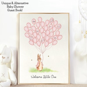 Może przedstawiać: Różowo-biała księga gości na baby shower z akwarelową ilustracją królika trzymającego różowe balony. Balony mają miejsce na wpisy gości. Tekst "Welcome Little One" znajduje się na dole obrazu.