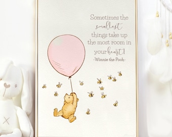 May include: A Winnie the Pooh quote print with a pink balloon and a bear holding on. The quote reads "Sometimes the smallest things take up the most room in your heart! -Winnie the Pooh-"