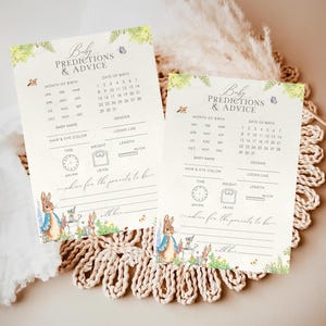 May include: Two printable baby shower game cards featuring a Peter Rabbit theme. The cards have a light blue and green floral design with a Peter Rabbit illustration. The cards include a list of predictions for the baby, such as the month of birth, date of birth, gender, baby name, hair and eye colour, looks like, time of birth, weight, and length.