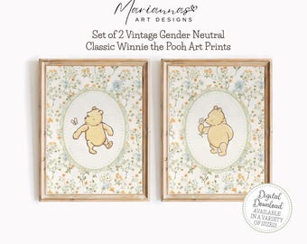 May include: Two framed art prints featuring Winnie the Pooh. Each print has a floral background and an oval frame with a Winnie the Pooh illustration. One print shows Pooh with a butterfly, the other with a flower. The text reads "Set of 2 Vintage Gender Neutral Classic Winnie the Pooh Art Prints."