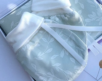 A pair of Silk Anti-Scratch Baby Mittens. Helps with soothing eczema, irritated skin