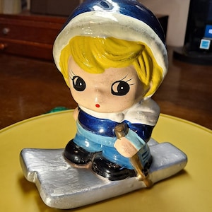 Vintage ceramic boy skiing piggy bank hand painted very good condition