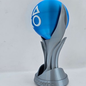 May include: A silver 3D printed trophy with a blue sphere on top. The sphere has the PlayStation logo on it. The base of the trophy says "Engineering".