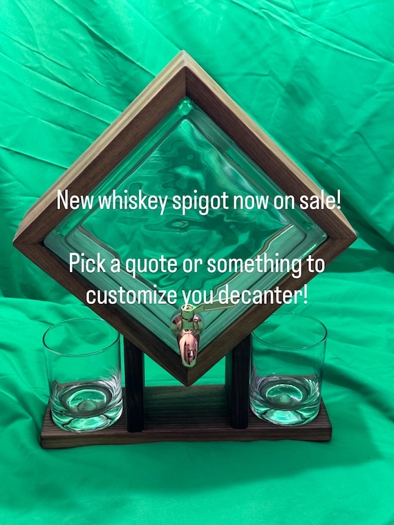 A solid walnut-and-glass block decanter with a copper spigot and custom engraving — it's genuinely sculptural, not just a bottle with a name on it.