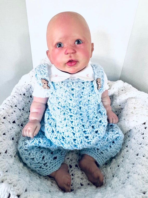 Crochet baby sweater, dress, and booties. Crochet baby sweater, dress, and booties.
