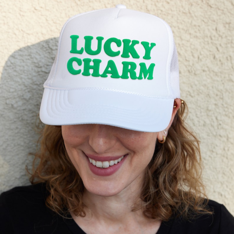 a woman wearing a white lucky charm hat