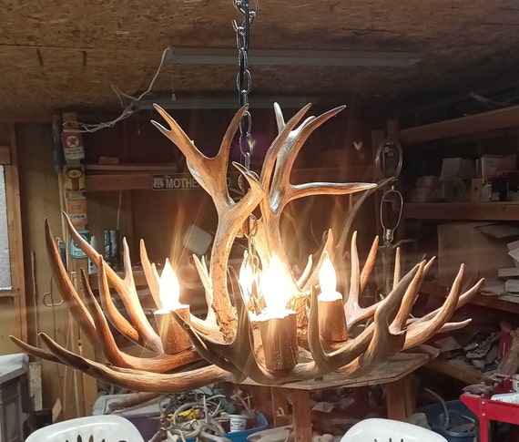 Real Antler Chandelier Ceiling pendant 25 inch diameter. Real antlers four lights log cabin decor. Rustic country living design.