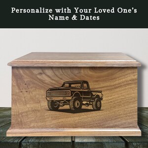May include: Wooden box with a truck graphic. The box is made of light brown wood and has a rectangular shape with a flat top. The text "Personalize with Your Loved One's Name & Dates" is at the top.