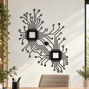 May include: A black metal wall art piece featuring a complex circuit board design with two large central square processors connected by intricate lines, nodes, and smaller square components, creating a technical, geometric pattern.