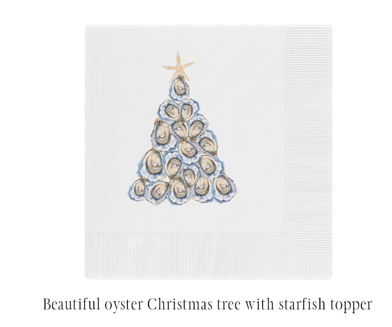 May include: A white paper napkin with a blue and white oyster Christmas tree with a starfish topper. The napkin is folded in half and the tree is in the center of the napkin.
