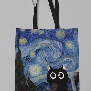 May include: A black canvas tote bag with black straps. The bag features a print of Vincent van Gogh's "Starry Night" with a black cat looking up at the stars.