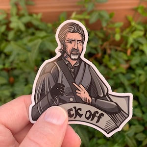 May include: A sticker featuring a cartoon illustration of a man with a beard and mustache wearing a dark gray coat and a white shirt. The man is giving a middle finger and the sticker has the text "F*ck Off" on a white banner.
