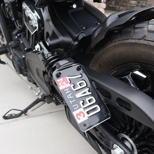 May include: Close-up of a black motorcycle with a Utah license plate that reads "30AC67".