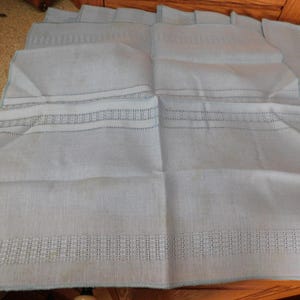 May include: A set of three ceramic mugs with a speckled, matte finish. The mugs are in shades of cream, light gray, and dark gray. Each mug has a simple, minimalist design and a rounded handle.