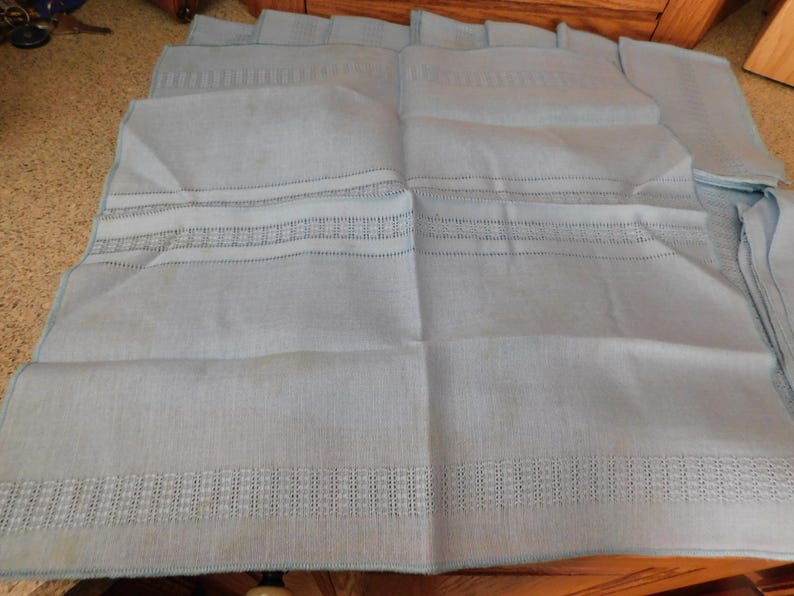 May include: A set of three ceramic mugs with a speckled, matte finish. The mugs are in shades of cream, light gray, and dark gray. Each mug has a simple, minimalist design and a rounded handle.