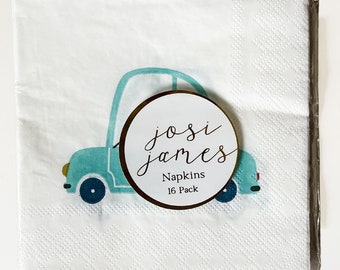 Peut inclure: Une serviette en papier blanche avec un motif de voiture bleue et un cercle brun avec le texte "josi james Napkins 16 Pack".