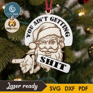 May include: Wooden Christmas decoration depicting a winking Santa Claus with the text "YOU AIN'T GETTING SHIT." The ornament is laser-cut and has a red ribbon for hanging. The bottom of the ornament reads "Laser ready" and includes file type options.