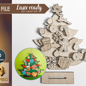 May include: Laser cut wooden Christmas tree craft kit with SVG file. The kit includes a base, a tree, and various ornaments, including a star, a reindeer, a candy cane, a snowflake, a gingerbread man, and a stocking. The ornaments are designed to be assembled on the tree.