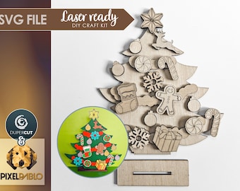 May include: Laser cut wooden Christmas tree craft kit with SVG file. The kit includes a base, a tree, and various ornaments, including a star, a reindeer, a candy cane, a snowflake, a gingerbread man, and a stocking. The ornaments are designed to be assembled on the tree.