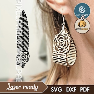 May include: Laser cut wooden earrings featuring a rose design. The earrings are teardrop shaped and have a geometric pattern.
