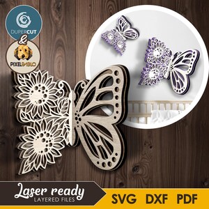 May include: Wooden butterfly wall art with sunflower and butterfly wing designs. The layered design features natural wood tones and purple accents. The image also includes the text "Laser ready" and "SVG DXF PDF".