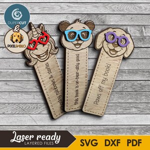 May include: Wooden bookmarks featuring a unicorn, panda, and dog, each wearing glasses. The unicorn has red heart-shaped glasses, the panda has blue glasses, and the dog has purple glasses. Text on the bookmarks reads "Chasing rainbows & stories", "This book is un-bear-ably good", and "Paws off my book!"