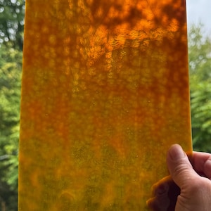 May include: A rectangular sheet of translucent amber and yellow stained glass with a mottled, textured surface. A white label in the top left corner displays the text 6.5 x 13, indicating the dimensions in inches.