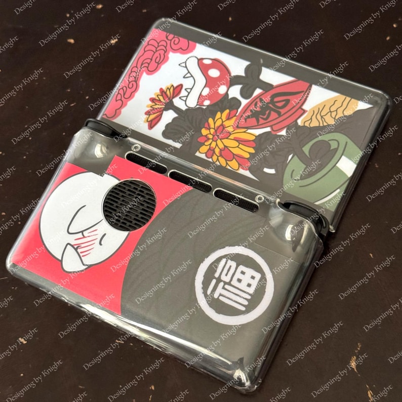May include: Clear plastic Nintendo Switch case with colorful Japanese-inspired artwork. The design includes a white rabbit, flowers, and a Japanese character. The case is open, revealing the screen and controls.
