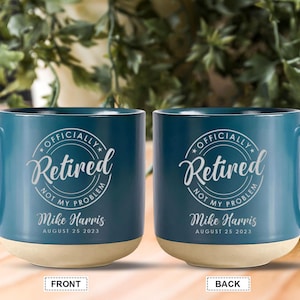 May include: Two teal blue ceramic mugs with a white design that says "Officially Retired Not My Problem" with a name and date. The front of the mug has the text "Mike Harris August 25 2023".