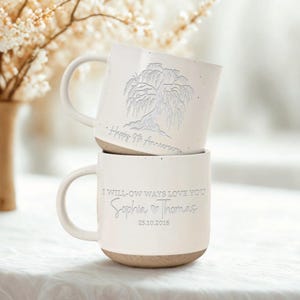 May include: Two stacked white ceramic mugs with a speckled base. The top mug features a willow tree design and the text "Happy 9th Anniversary." The bottom mug has the text "I will-ow ways love you Sophia & Thomas 25.10.2016."