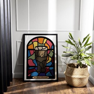 May include: A framed print of a stained glass window design featuring a glass of Guinness beer. The window is made up of colorful pieces of glass in shades of red, orange, yellow, green, blue, and purple. The text at the bottom of the print reads "Sir Arthur Guinness".