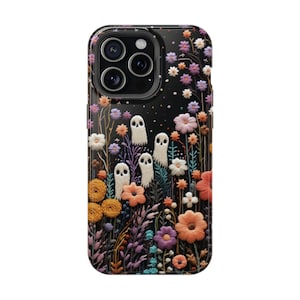 May include: A black phone case with a colorful embroidered design of flowers and ghosts. The case has a clear back and a black border.