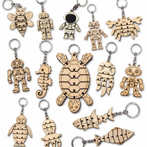 May include: A collection of 20 laser-cut wooden keychains in various shapes, including a bee, robots, an astronaut, a crab, a seahorse, a turtle, a jellyfish, a penguin, an octopus, and fish. The keychains are made of 3 mm material and are flexible.