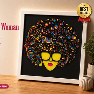 May include: A framed laser-cut multilayer shadow box featuring a woman with vibrant, colorful curly hair, yellow sunglasses, and a pink mouth. The artwork is set against a black background within a white frame. The text "Curly Hair Woman" is visible.