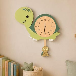May include: A whimsical, green and yellow dinosaur-shaped wall clock with a pendulum. The clock face is a light peach color with black numbers and hands. A framed dinosaur print and a plush dinosaur toy are also visible.