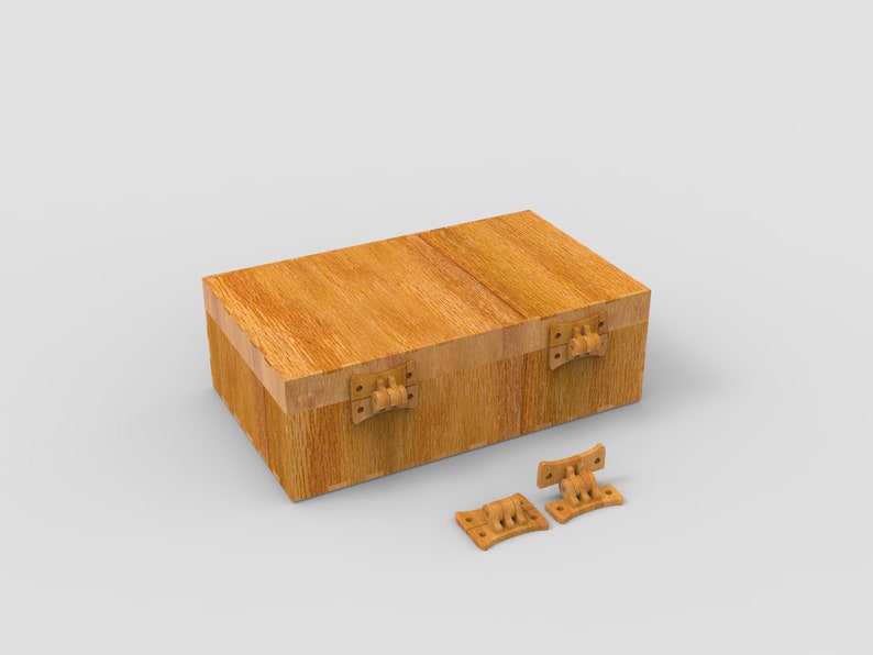 May include: A rectangular wooden box with a hinged lid and two detached hinges. The box is made of light brown wood with visible grain and has a simple, classic design. The hinges are also made of wood and are a lighter shade of brown.