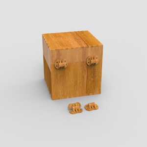 May include: A wooden box with a cube shape, featuring visible wood grain and two hinges on the front. Two additional hinges are placed below the box. The box is made of light brown wood.