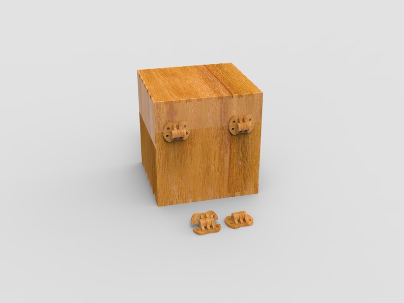 May include: A wooden box with a cube shape, featuring visible wood grain and two hinges on the front. Two additional hinges are placed below the box. The box is made of light brown wood.