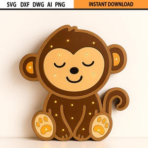 Może przedstawiać: Brązowa lampa w kształcie małpy z jasnobrązową twarzą, uszami i łapami. Małpa ma zamknięte oczy i uśmiechnięte usta. Obraz zawiera tekst "SVG DXF DWG AI PNG" i "INSTANT DOWNLOAD".