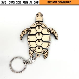 May include: A wooden turtle keychain with a silver keyring. The turtle is light brown with a segmented design, featuring a geometric pattern on its shell and dotted details on its flippers. The image also includes the text "INSTANT DOWNLOAD".