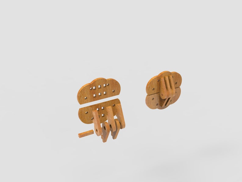 May include: Wooden puzzle pieces in the shape of a hand, with a cloud-like top. The pieces are light brown and appear to be unassembled. The design includes a fist and a separate cloud-shaped piece with small square holes.