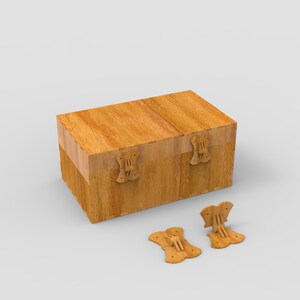 May include: A rectangular wooden box with a hinged lid and decorative butterfly-shaped clasps. The box is made of light-colored wood and has a natural grain pattern. Two detached clasps are visible.
