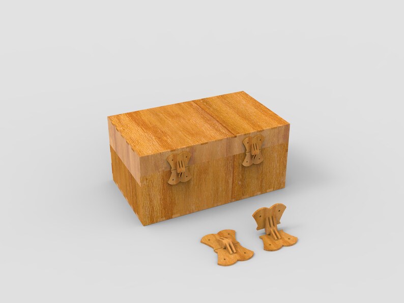 May include: A rectangular wooden box with a hinged lid and decorative butterfly-shaped clasps. The box is made of light-colored wood and has a natural grain pattern. Two detached clasps are visible.
