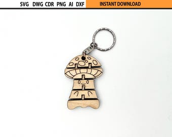 May include: A wooden mushroom-shaped keychain with a silver keyring. The mushroom has a smiling face and is made of interlocking pieces. The top of the image has the text "SVG DWG CDR PNG AI DXF" and "INSTANT DOWNLOAD".