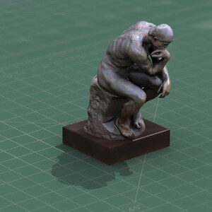 May include: A bronze sculpture of a man sitting and thinking, known as "The Thinker". The sculpture is on a dark brown square base.