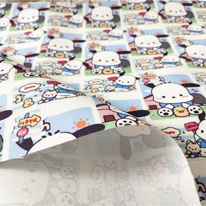May include: White fabric with a repeating pattern of a cartoon dog wearing a blue shirt and holding a ball. The dog is surrounded by other cartoon characters, including a small yellow chick. The fabric has a blue and white striped border.