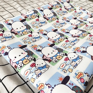 May include: White fabric with a repeating pattern of a cartoon dog wearing a blue shirt and holding a small yellow chick. The dog is surrounded by a blue and white border with Japanese text.